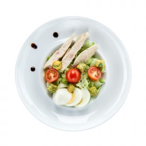 Caesar salad with chicken over white. With clipping path.
